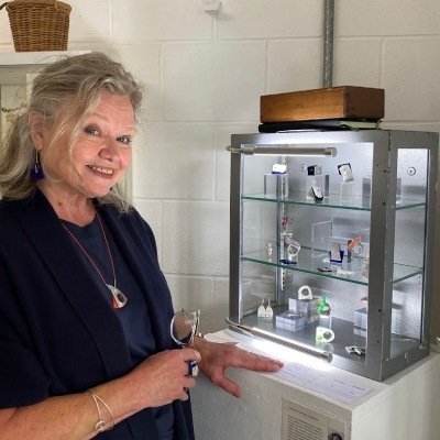 ceciel pictured in front of her display cabinet at jubilee wharf gallery
