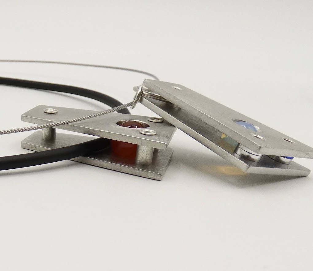 2 Hebbe pendants, one with red carnelian sphere insert and one with opalite sphere insert