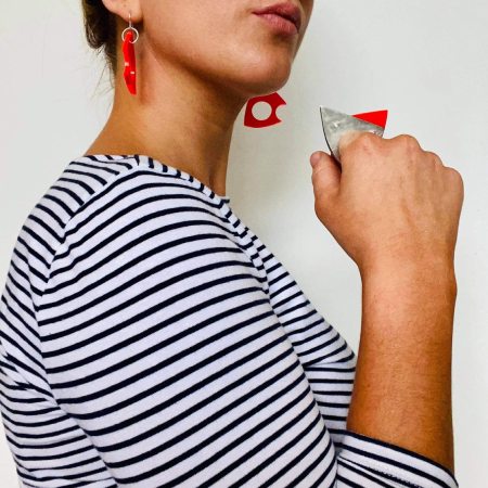 Model wearing stripy top and Dhoek ring and earrings in orange