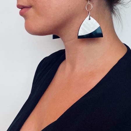 model wearing pewter and black Dhoek earring sdide view close up